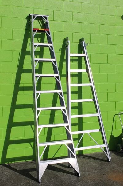 ladders, two ladders, green wall