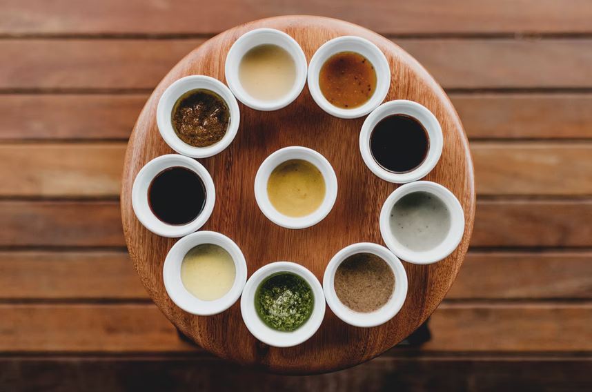 various kinds of sauces on a wooden table